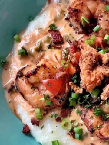 Shrimp and grits in creole cream sauce in a bowl.