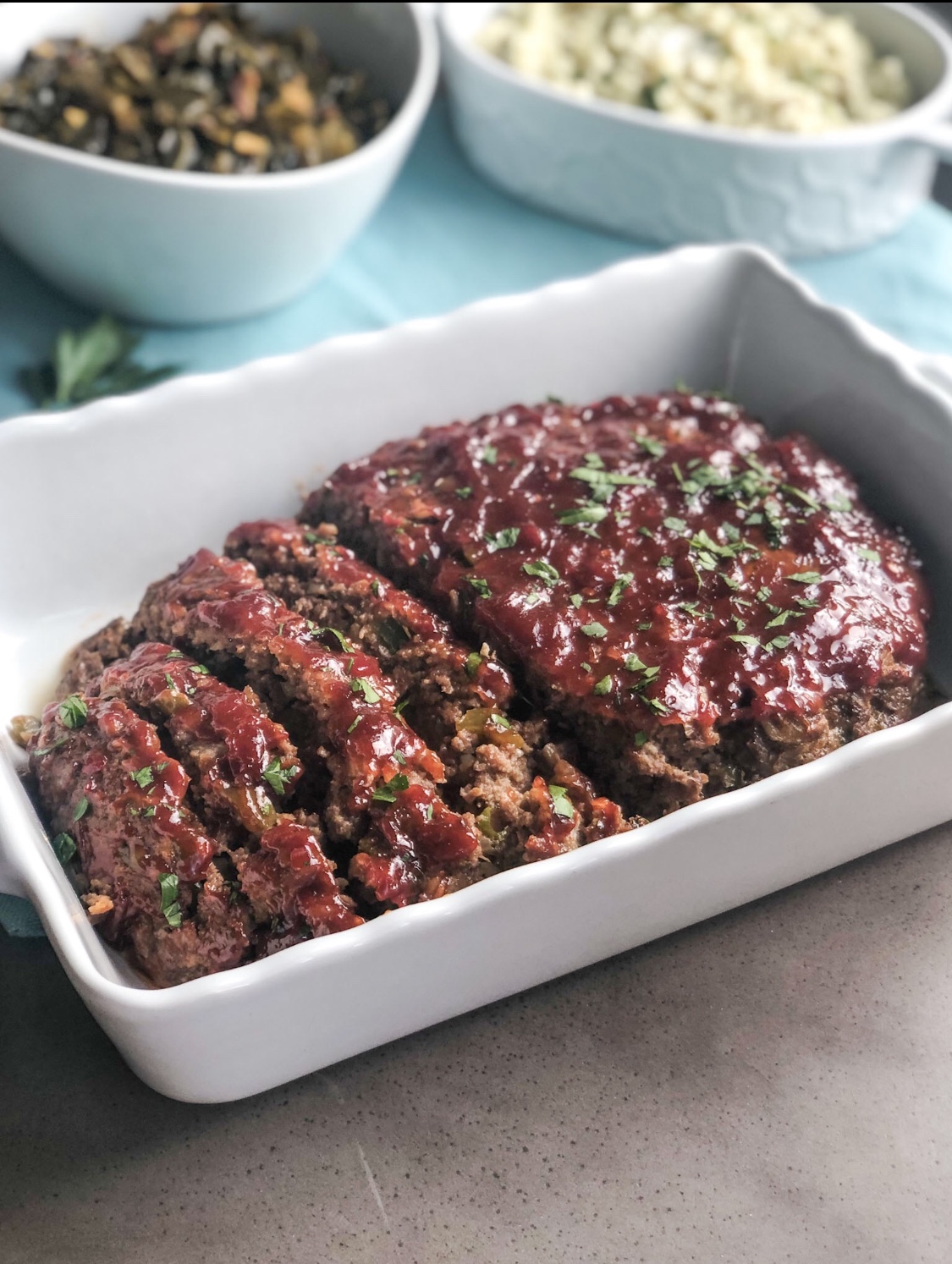 sliced meatloaf made without breadcrumbs in a serving dish