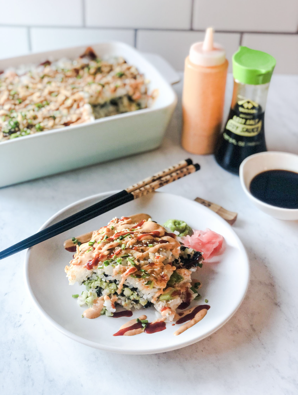 crab sushi bake plated crab sushi bake with chopsticks on the side, and soy sauce and the casserole dish in the background