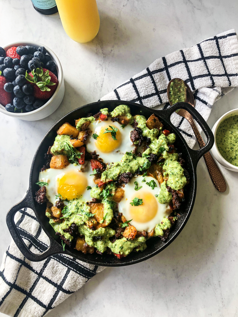 a skillet full of chorizo hash with poblano sauce