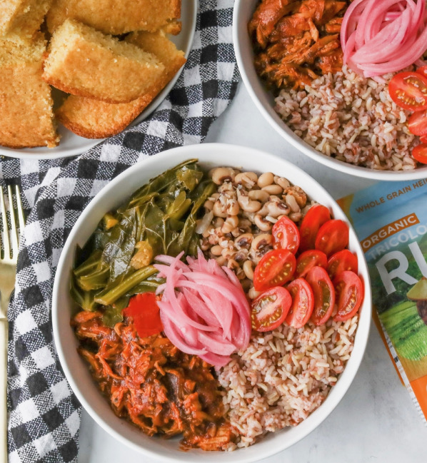 Authentic Soul Food in a Bowl with BBQ Chicken top down angle showing plated bowls, one bowl in full frame with a side of cornbread on a small white plate.