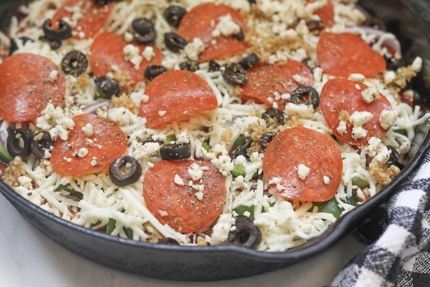 close up view of unbaked pizza casserole