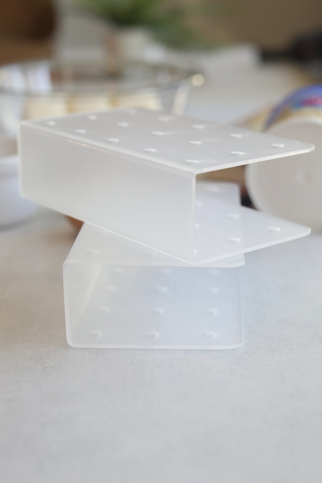 Cake pop stands with holes in a plastic rectangular shape.