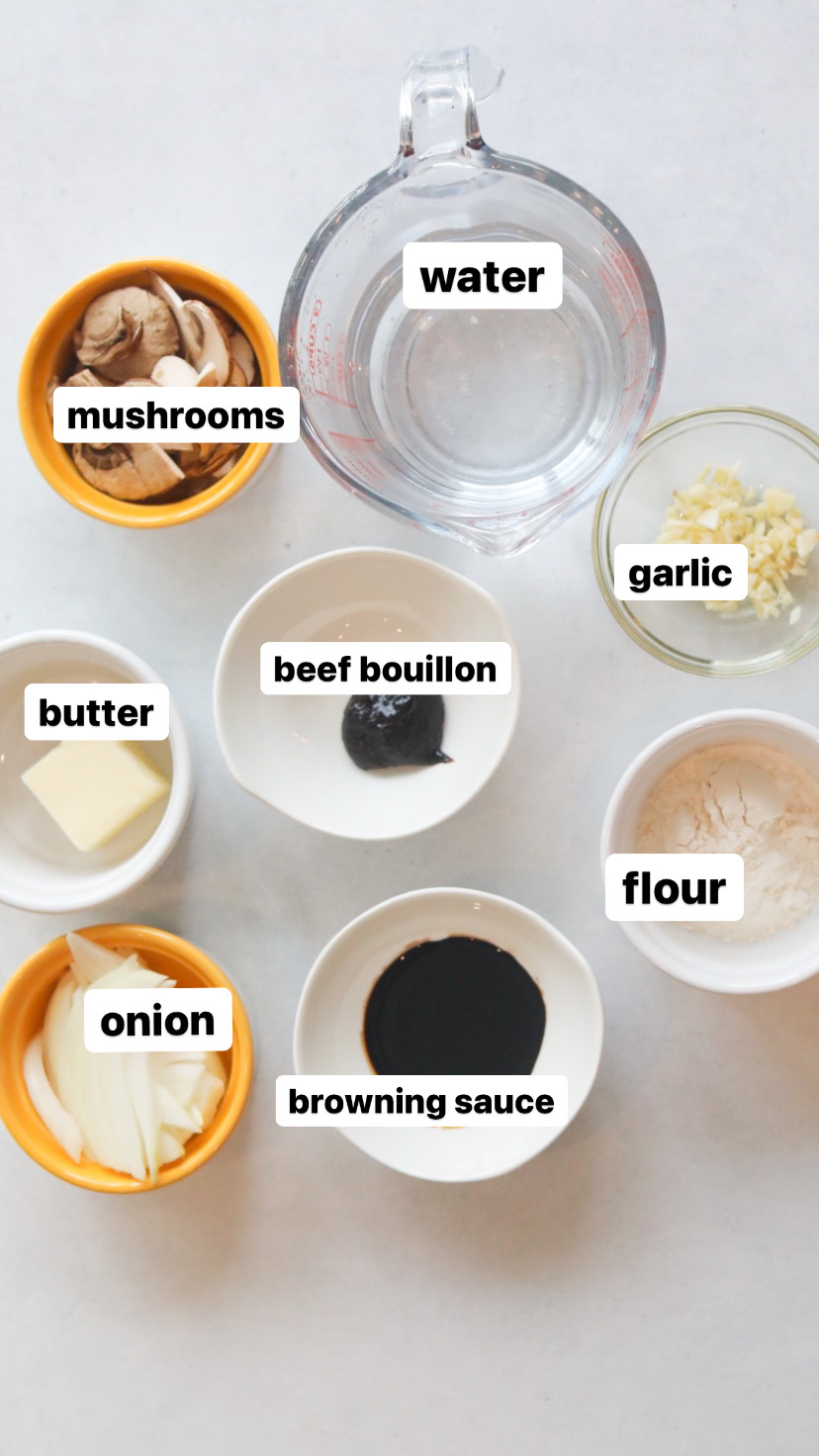 Loco Moco Gravy recipe ingredients in small yellow and white bowls. Water is in a clear measuring glass and additional ingredients are in a circular motion beginning with browning sauce and ending with onion.