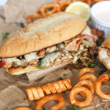 Salmon Cheese Caked styled with curly french fries and a white sauce bowl filled with remoulade sauce.