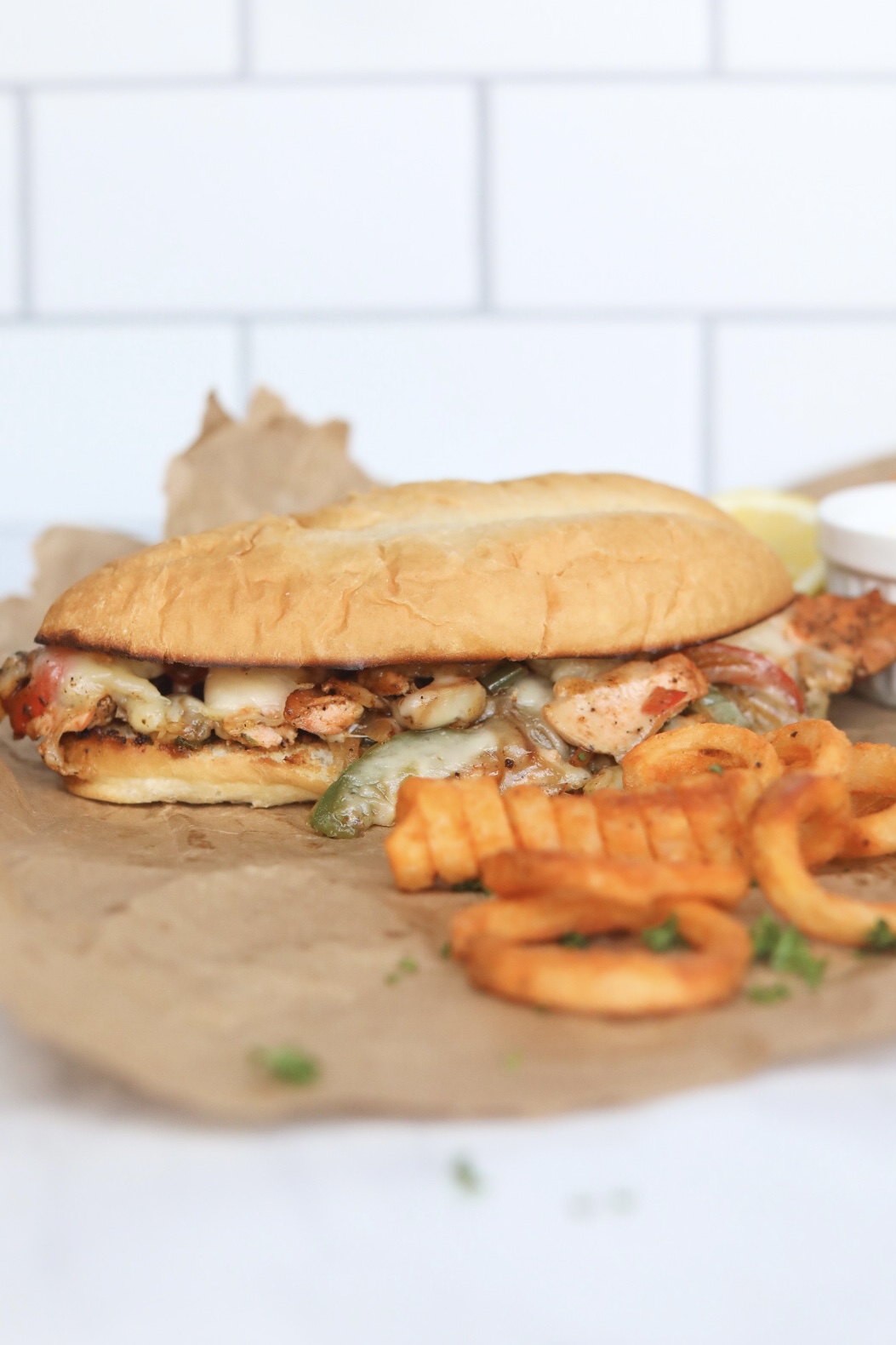 Salmon Cheesesteak with curly fries for styling purposes. 