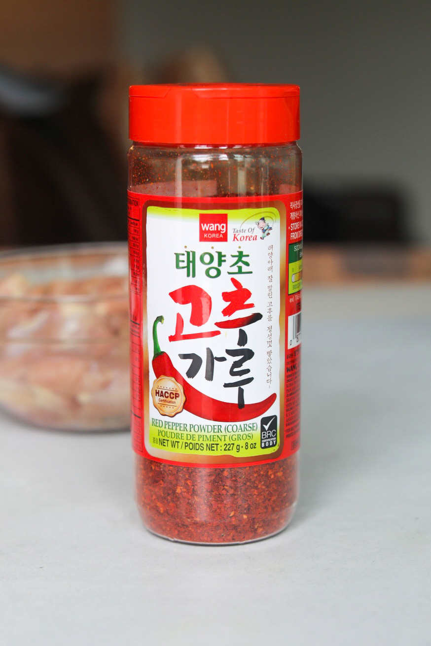 Spicy Chicken Teriyaki ingredient. Red Pepper Powder in a clear seasoning bottle with red top.