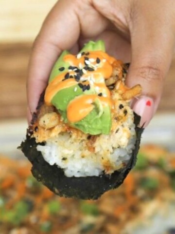 Crab sushi bake held by hand.