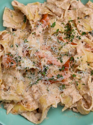 Top Down view of pasta al salmone recipe plated in a light teal shallow bowl.