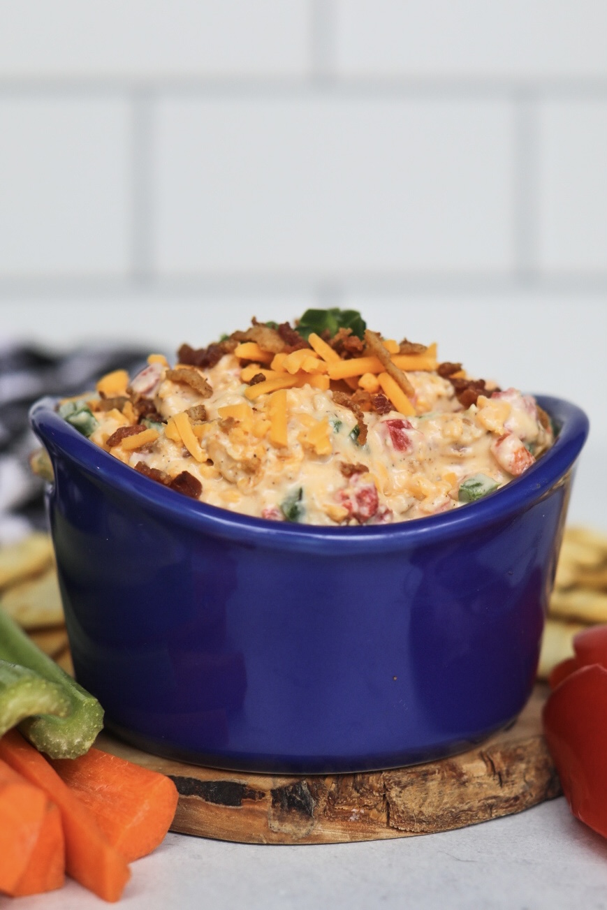 Spicy jalapeno pimento cheese topped with shredded cheddar cheese, crumbled bacon and diced jalapeno.