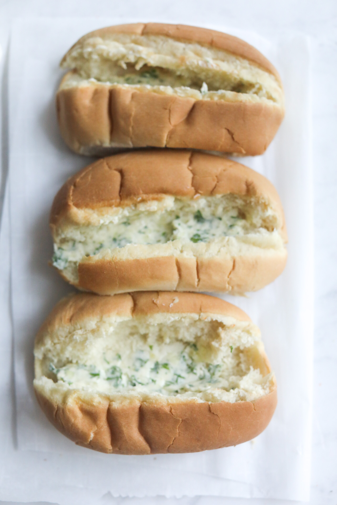 herbed butter slathered on hoagie rolls