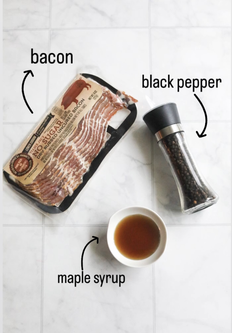 Ingredients for recipe. In a flat lay, top-down angle, black pepper in a bottle, bacon in a pack and a small white bowl with maple syrup.