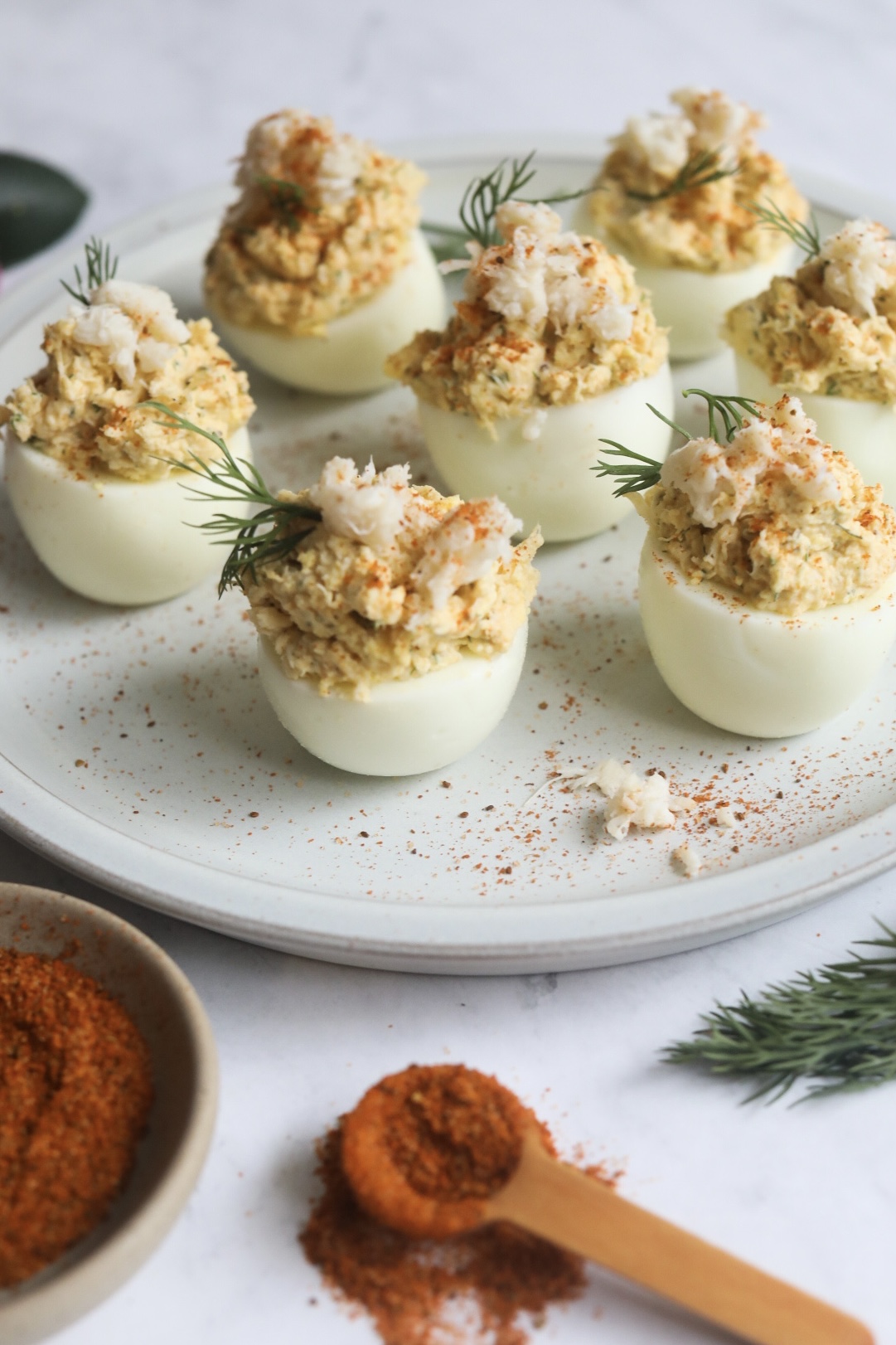 a plate full of deviled eggs with crab 