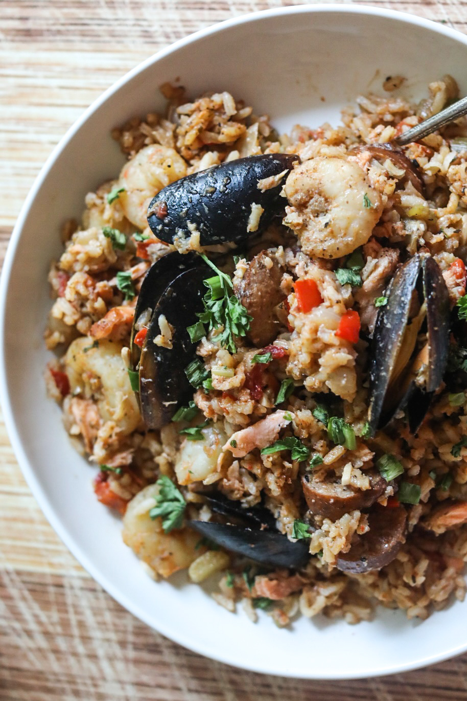 close up view of a half a bowl of jambalaya with seafood