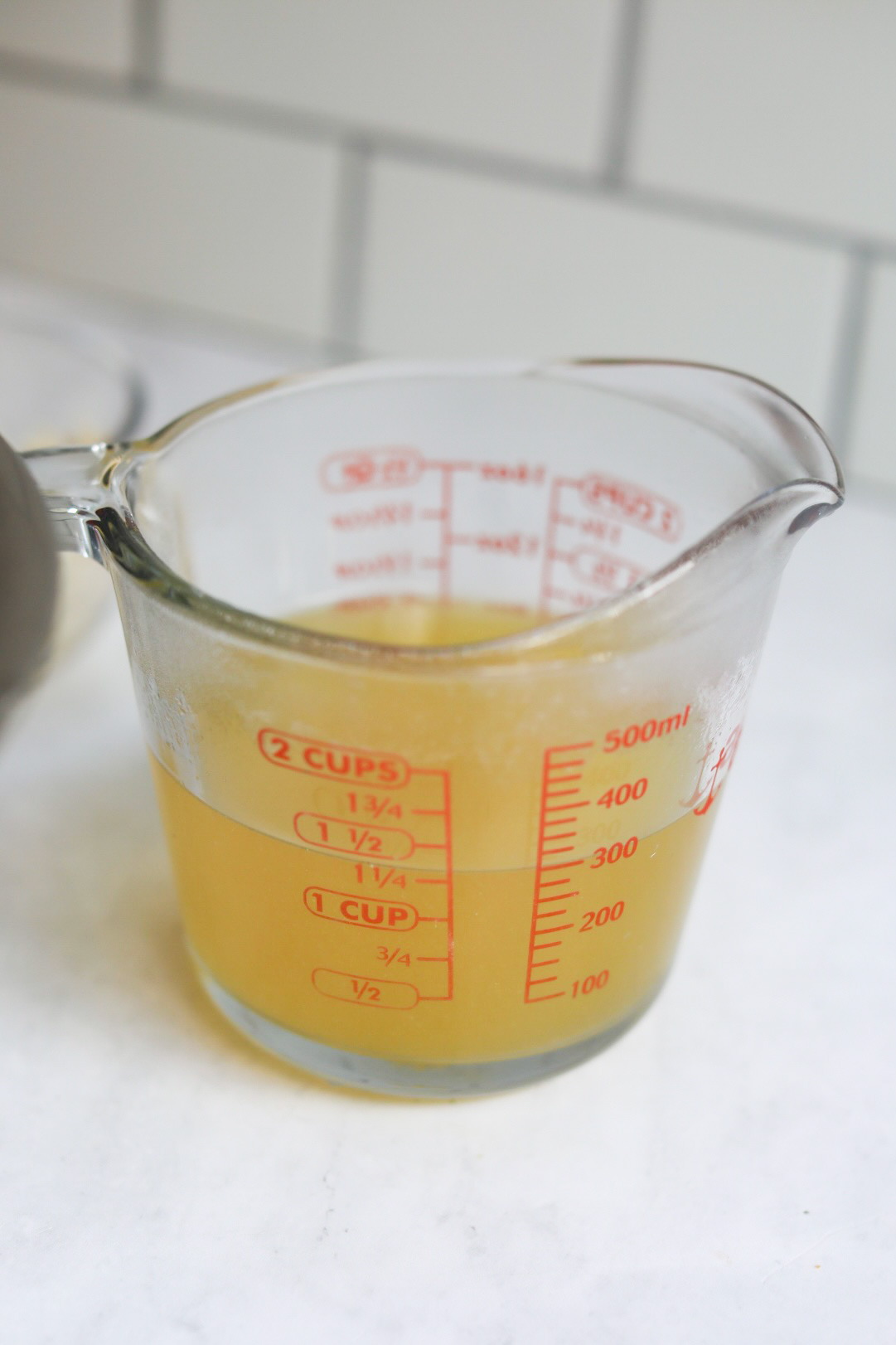 a measuring cup of seafood stock