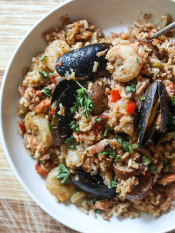 close up view of a half a bowl of jambalaya with seafood