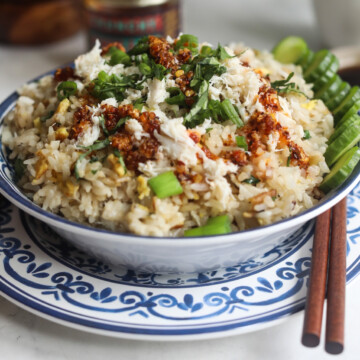 Crab fried rice finished recipe topped with green onion, cilantro and crunchy chili oil.