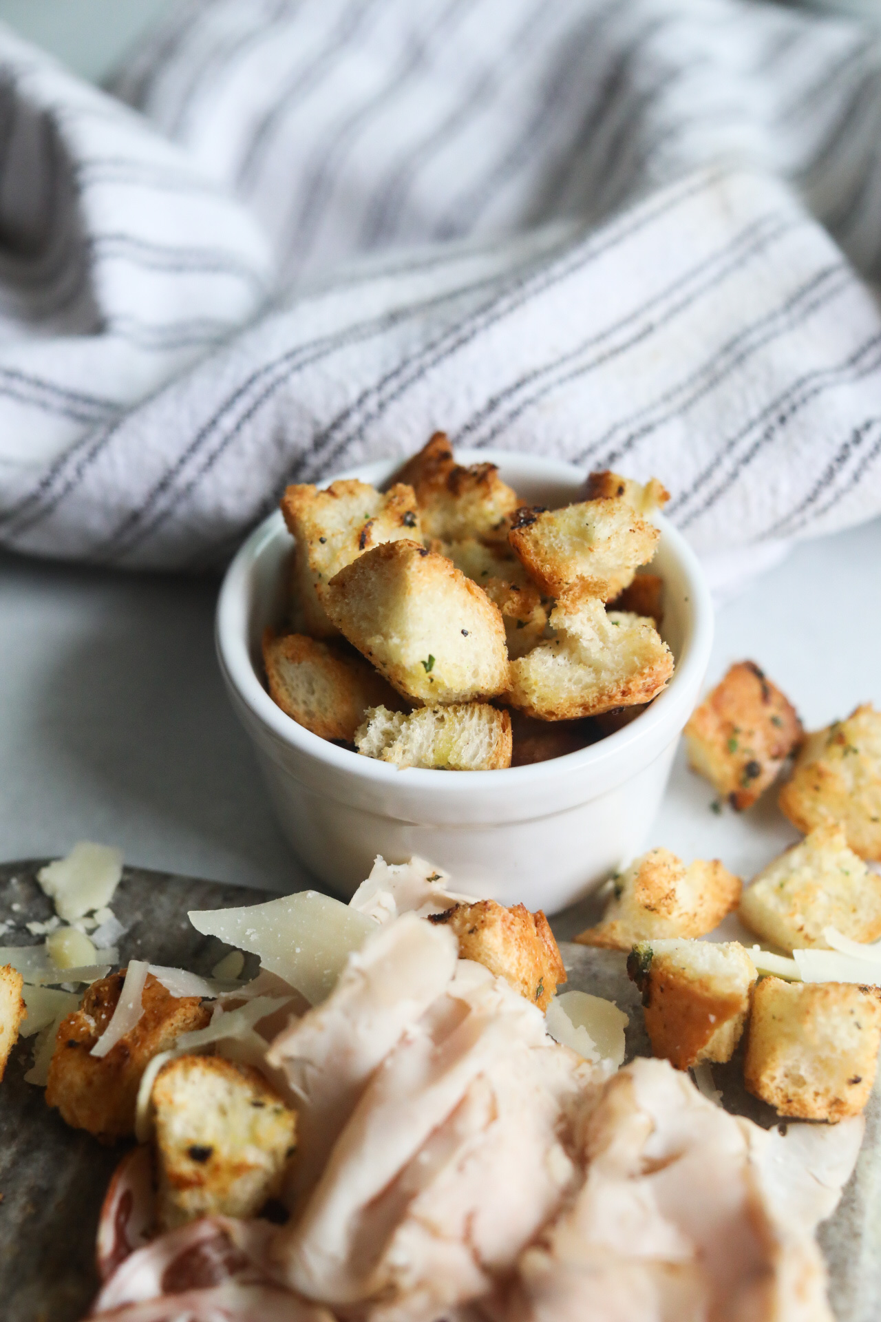 Final recipe image of baked croutons served in a small white bowl.