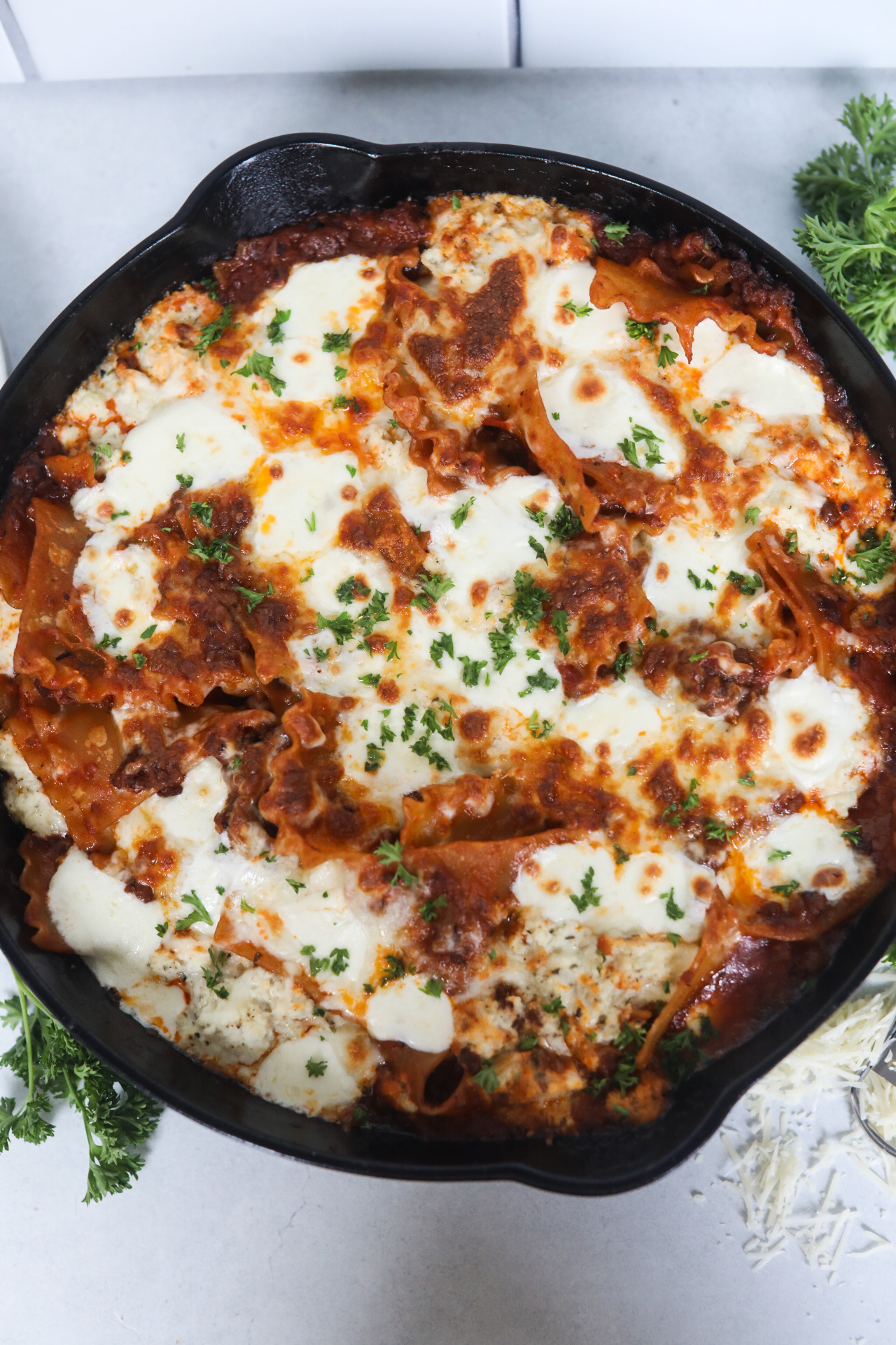 one pot lasagna no bake Top down image of one pot skillet lasagna in a black cast iron skillet.