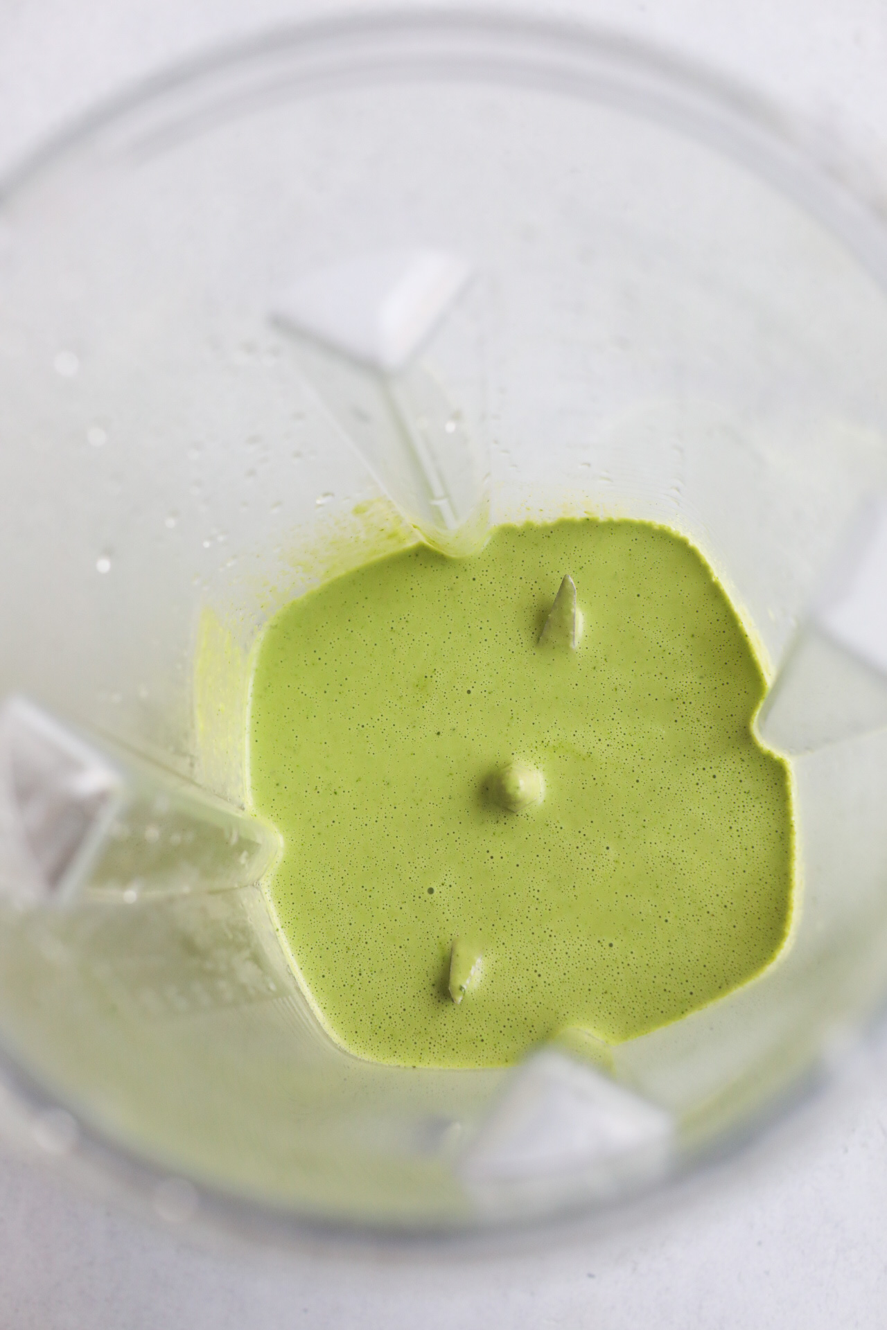 Cilantro lime sauce in a blender blended showing sauce.