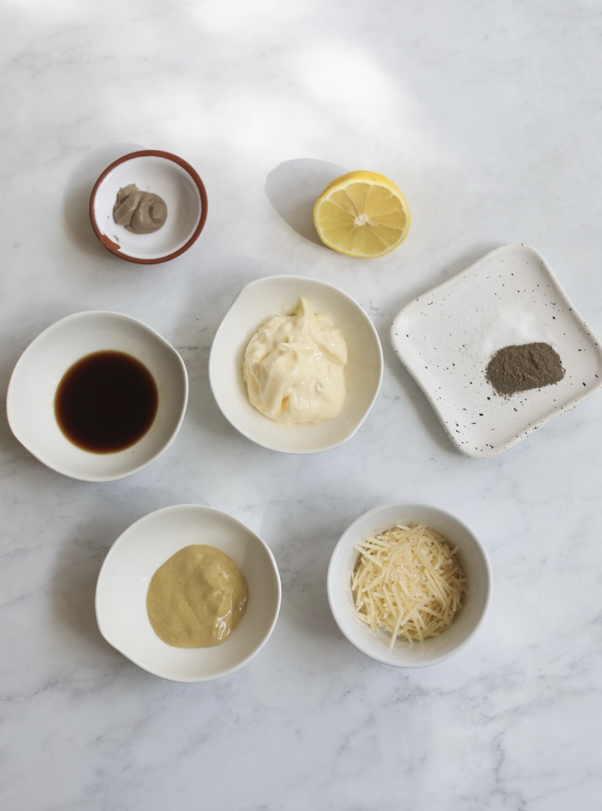 Caesar dressing ingredients in a flat lay.