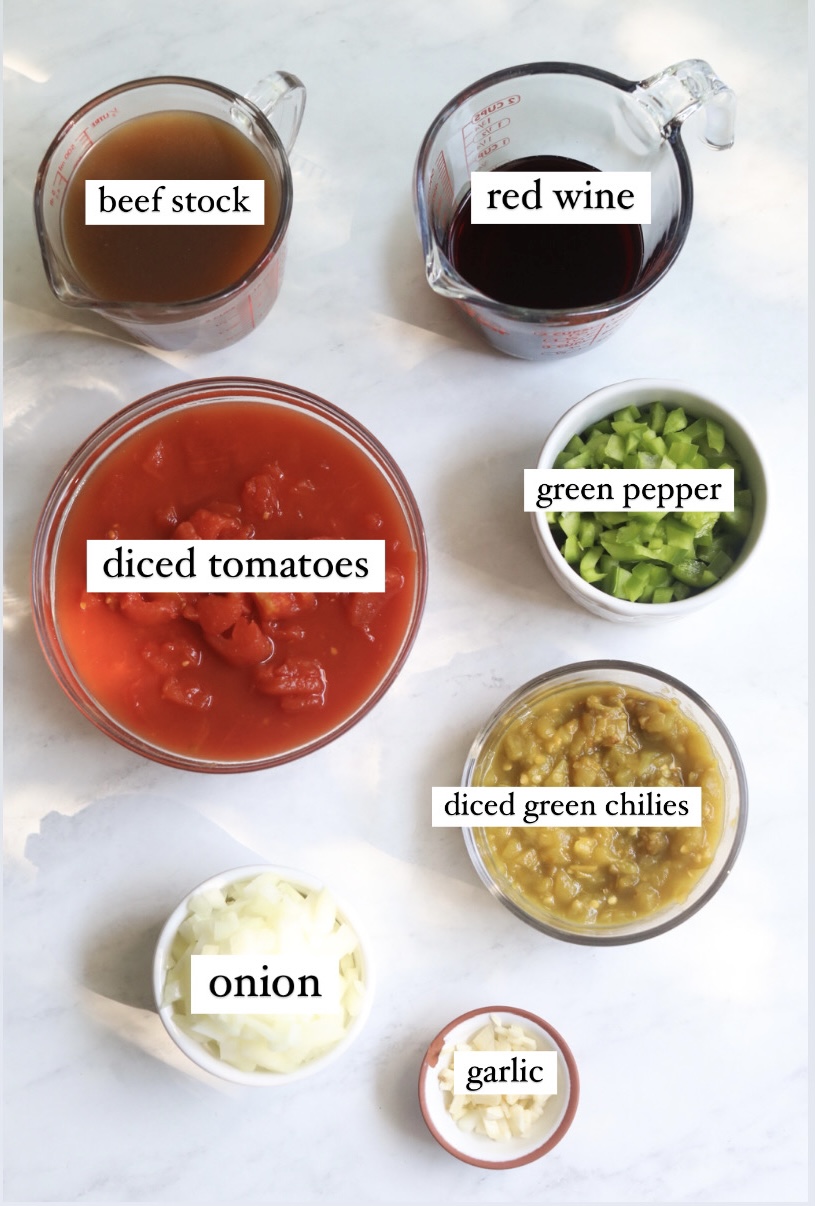 how to make sweet chili Sweet chili ingredients in a flat lay. Beef stock and red wine in a glass measuring cup, diced tomatoes, green pepper, dicd green chilies, onion and garlic.