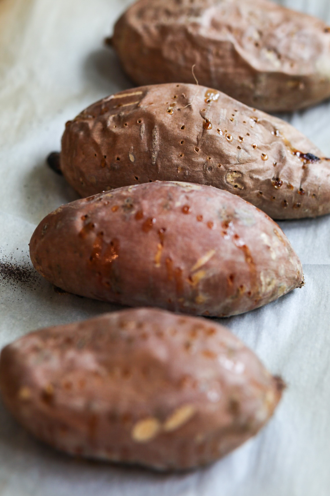 baked sweet potatoes with holes pierced into the skin