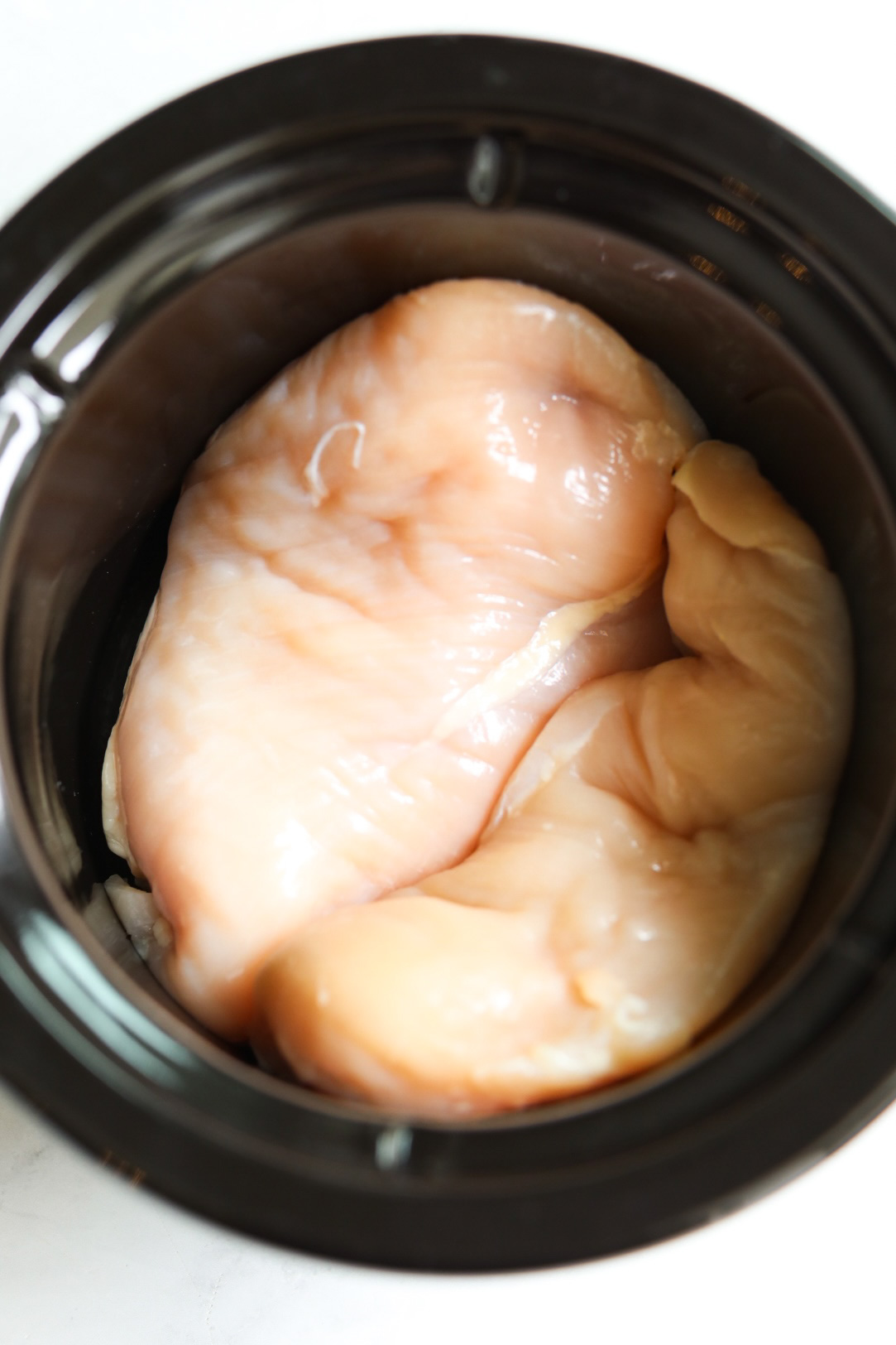 two large chicken breasts in a slow cooker