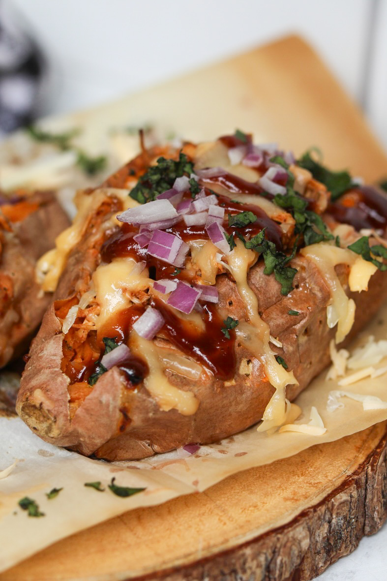 close up view of one baked sweet potato stuffed with slow cooked bbq chicken