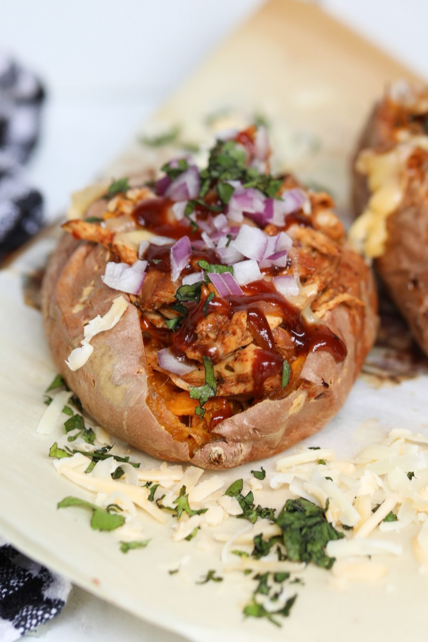 one baked sweet potato stuffed with slow cooked bbq chicken