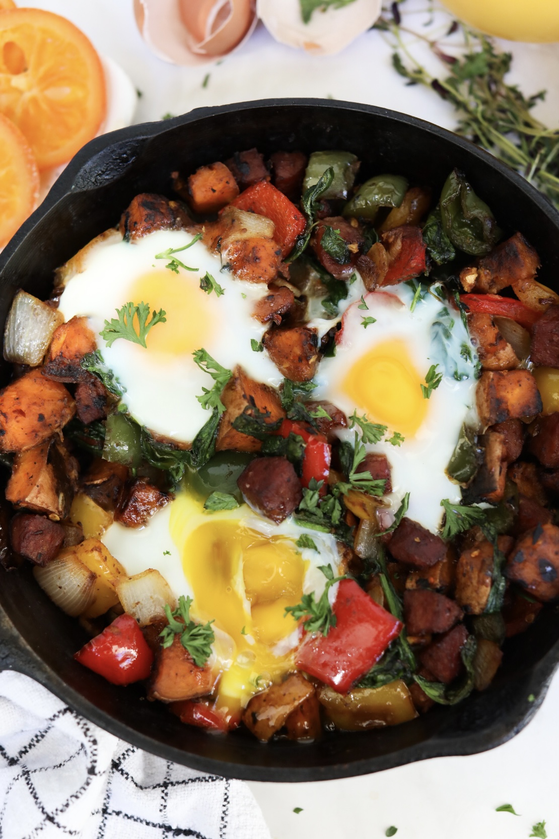Top view of sweet potato hash with final recipe and one runny egg.