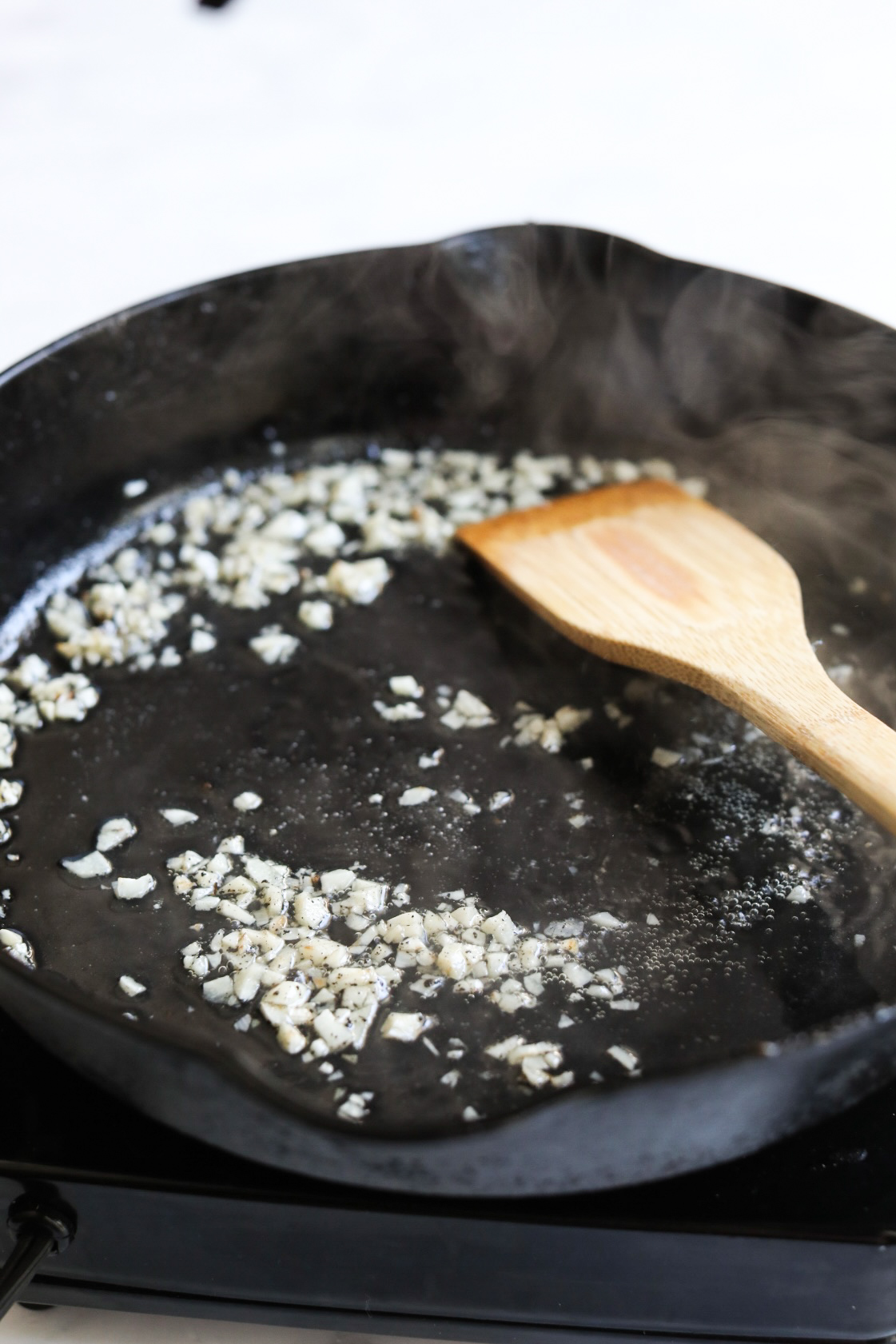 sautéing garlic in skillet