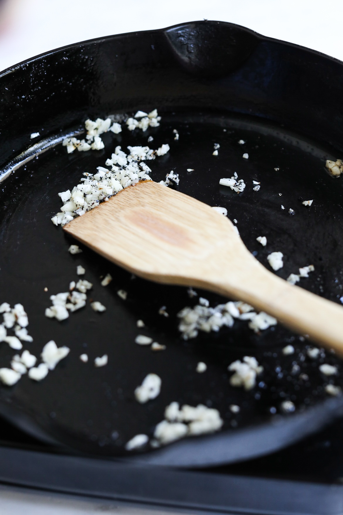 sautéing garlic in skillet