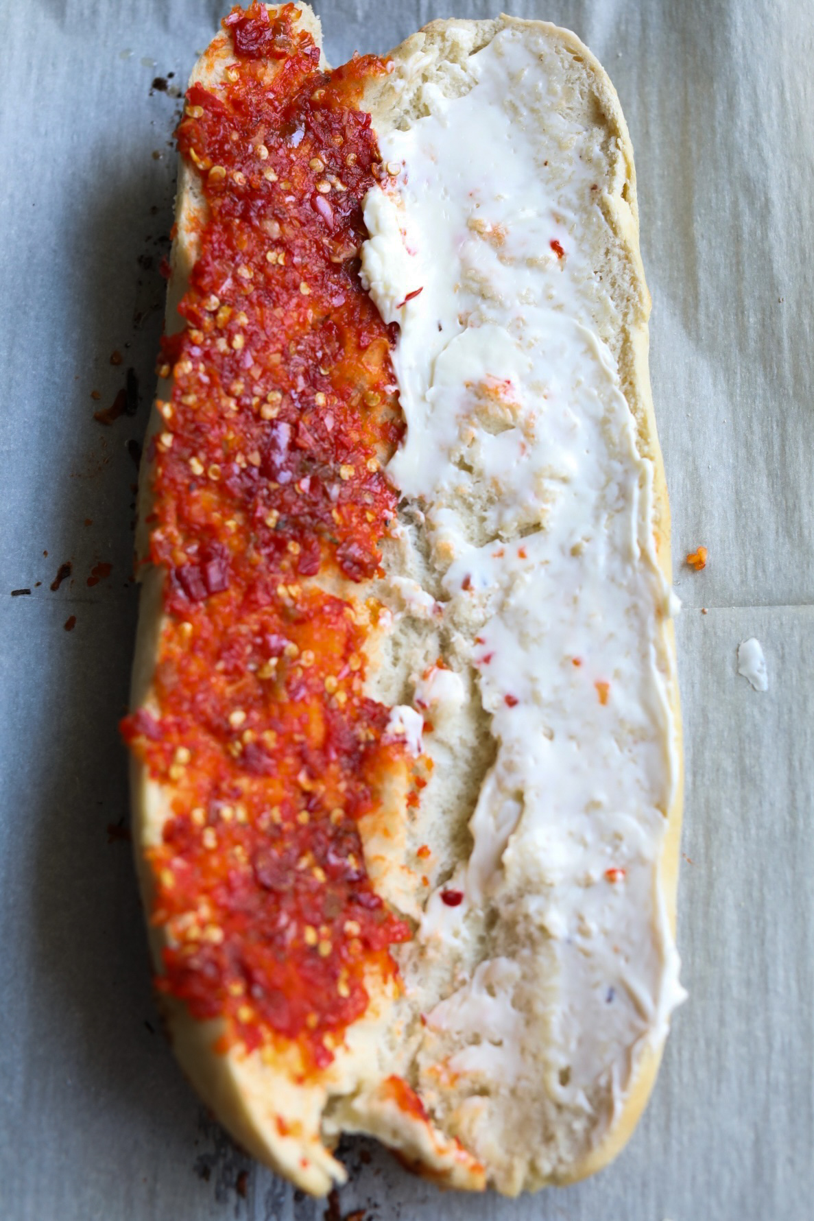 hot turkey sub sliced baguette with mayo on one half and cherry pepper relish on the other