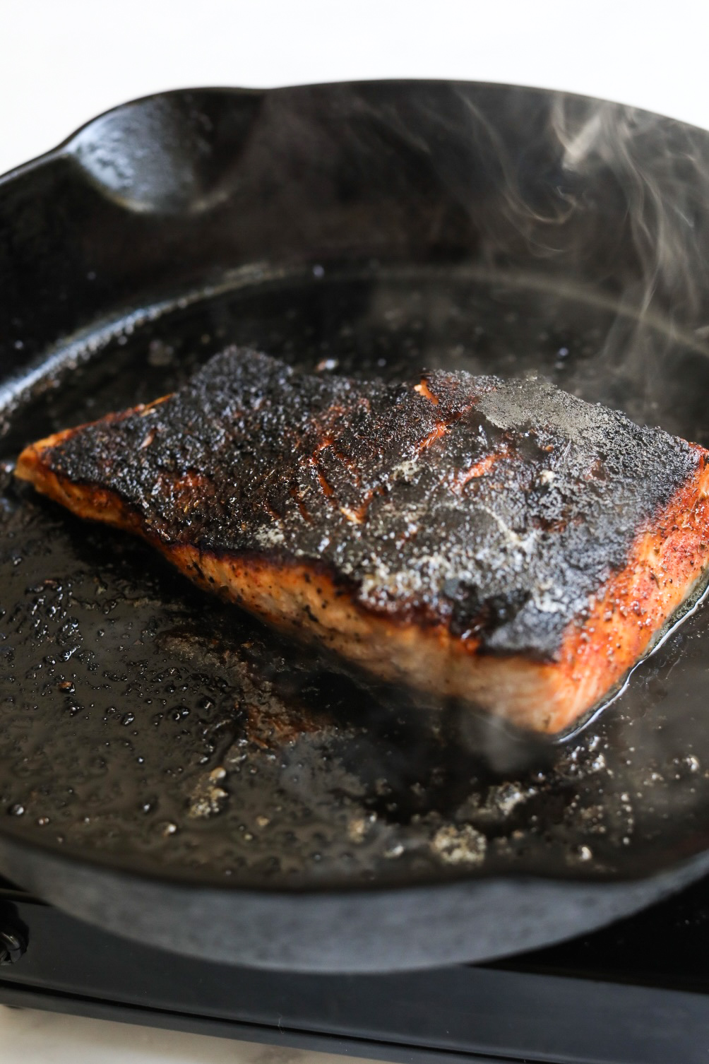 pan searing salmon in a skillet for salmon pasta