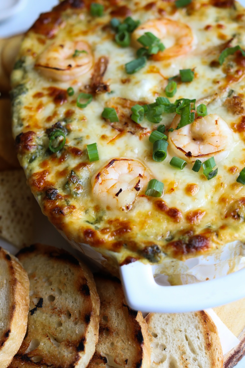 close up view of a casserole dish filled with crab and shrimp dip