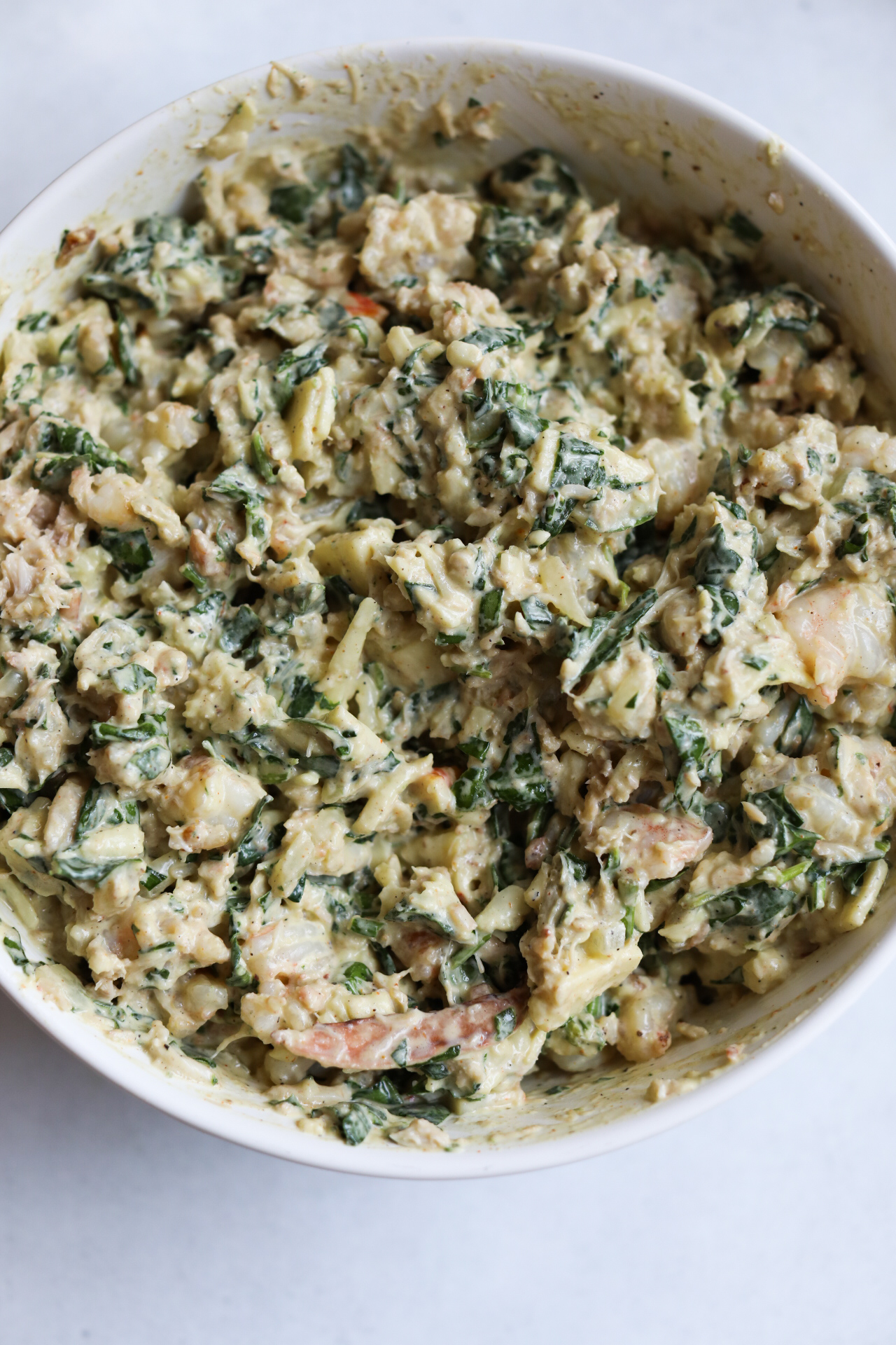 seafood dip mixed in a bowl before baking