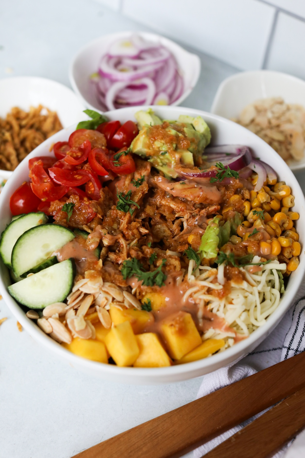 BBQ Ranch Salad plated in a white bowl with honey ginger dressing.