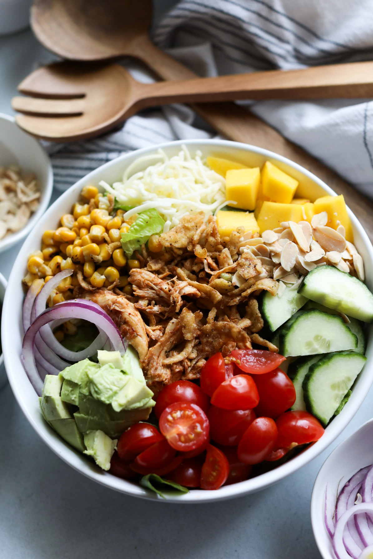 Top view of BBQ Chicken Salad recipe with all ingredients layered like a burrito bowl without dressing.