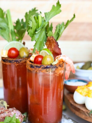 close up view of two glasses of Bloody Mary cocktails