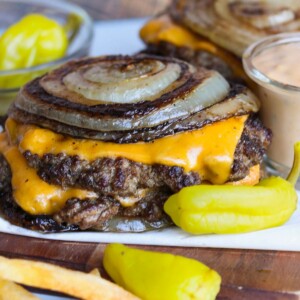 Final recipe of Flying Dutchman stacked with grilled onion rounds.