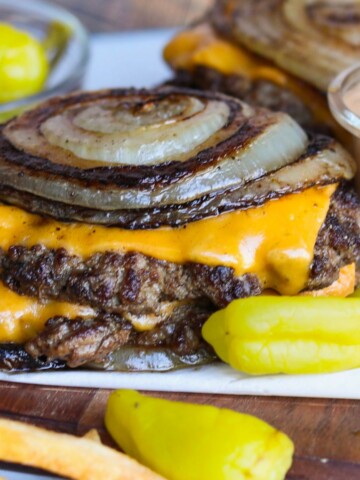 Final recipe of Flying Dutchman stacked with grilled onion rounds.