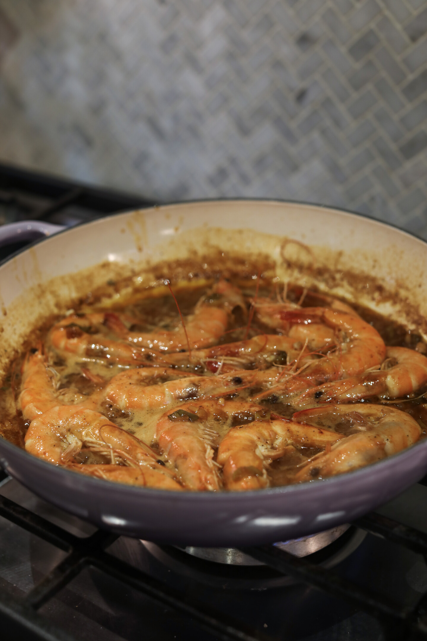 bbq shrimp in a pan on the stove