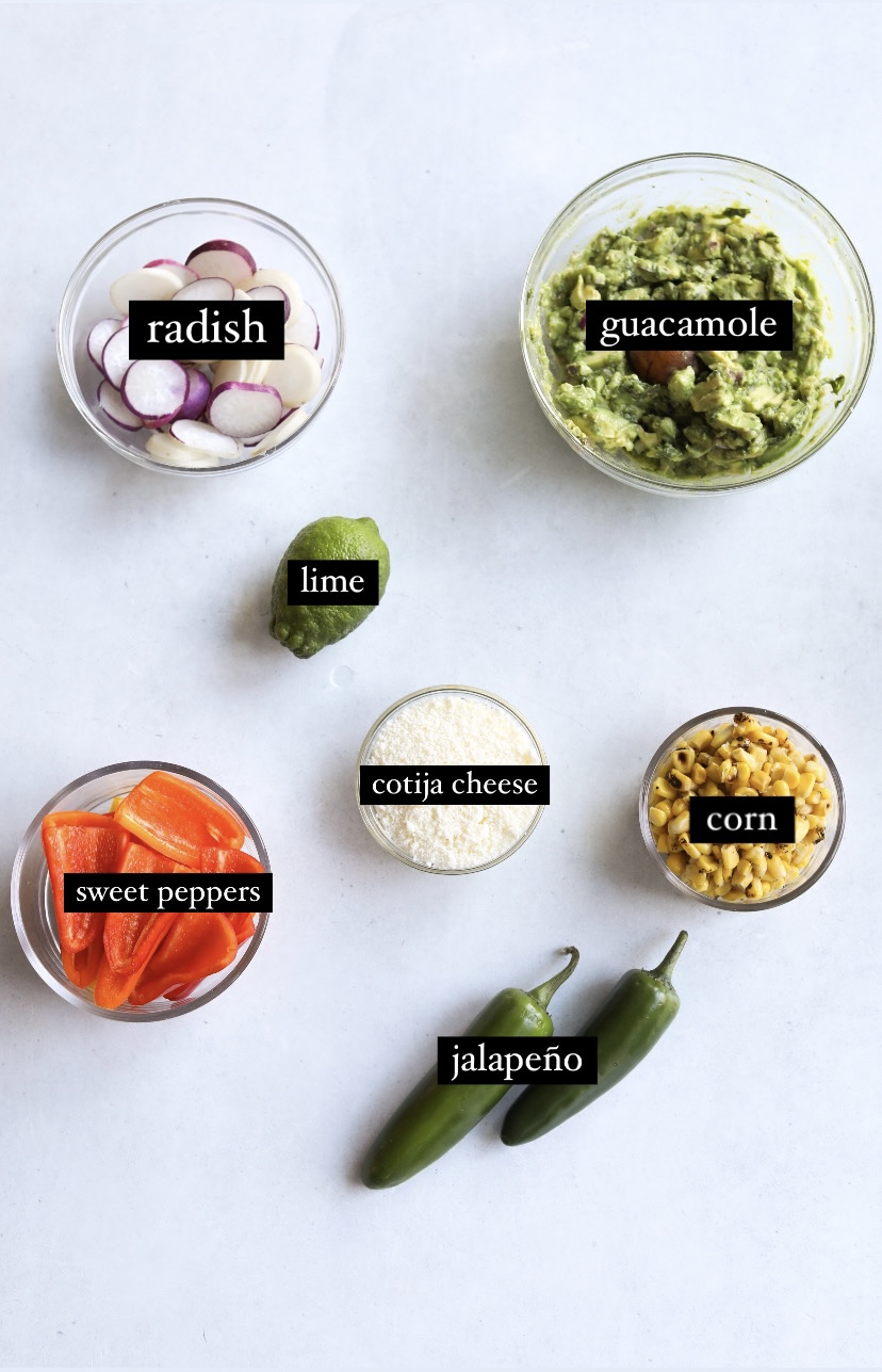 Vegetable toppings in a flat lay in small bowls.