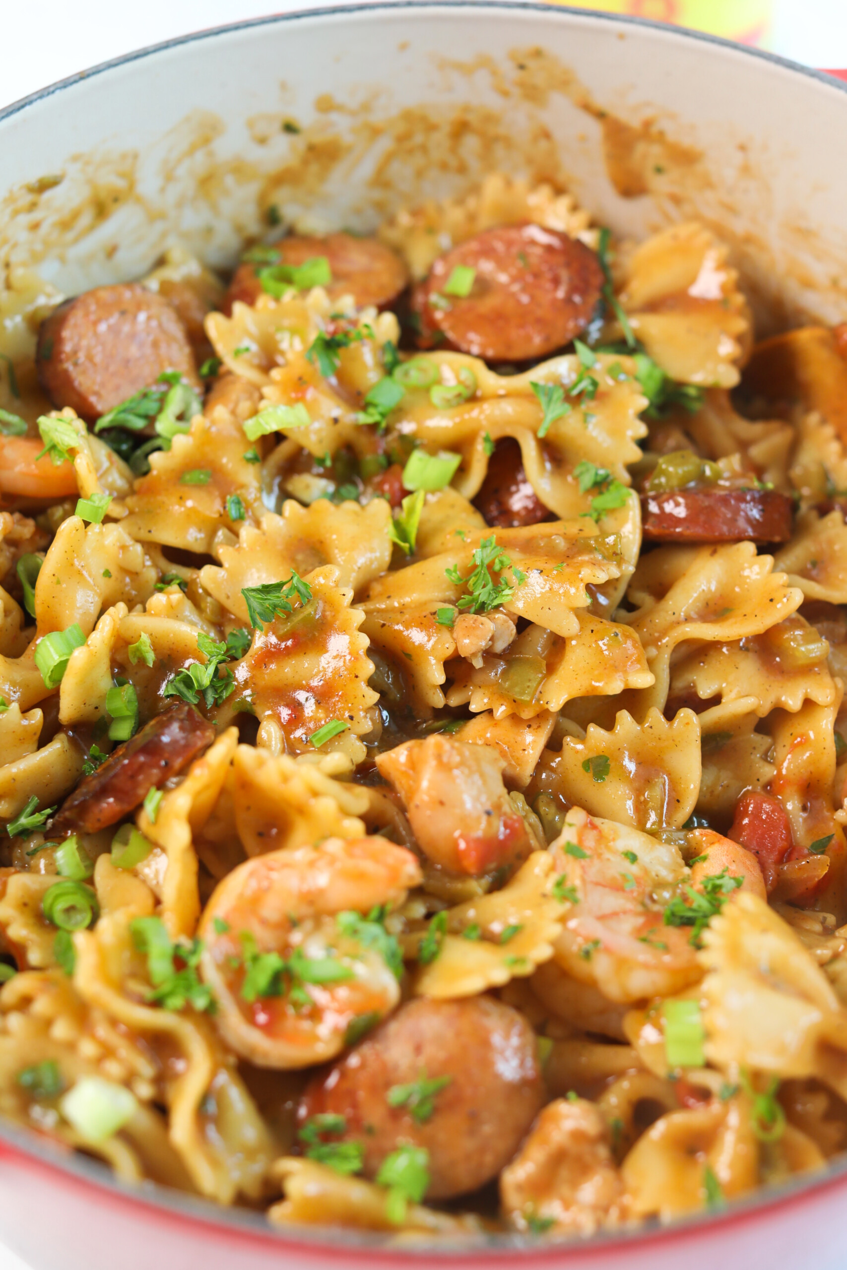 Pastalaya, final recipe in red pot, garnished with green onion and fresh parsley.