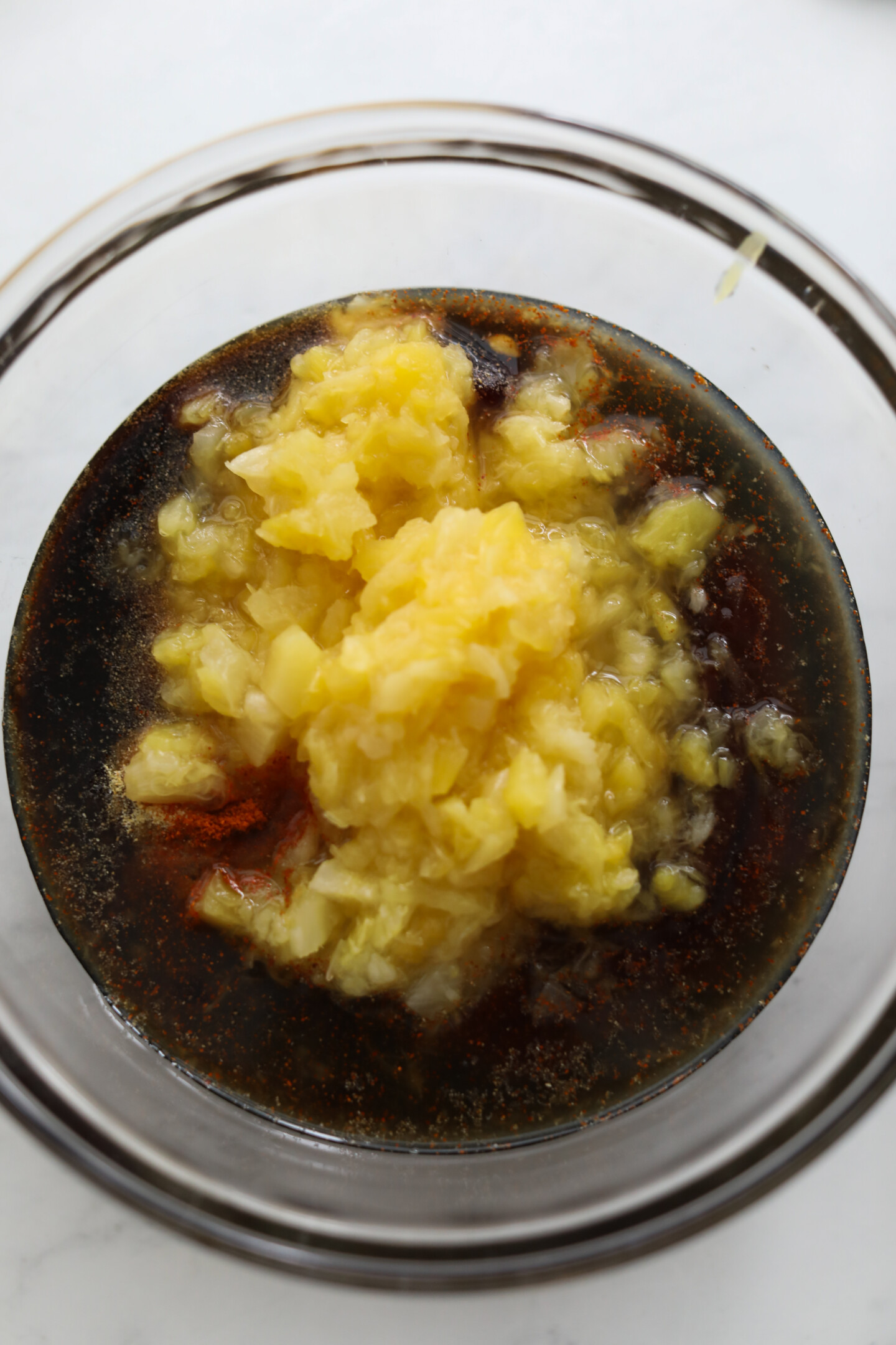 Meatball sauce ingredients in glass bowl.